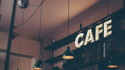 Coffee shop customer using loyalty app to earn rewards on phone